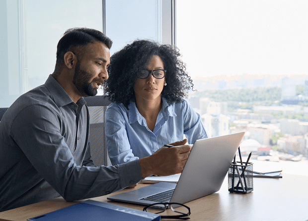 Two professionals reviewing documents together