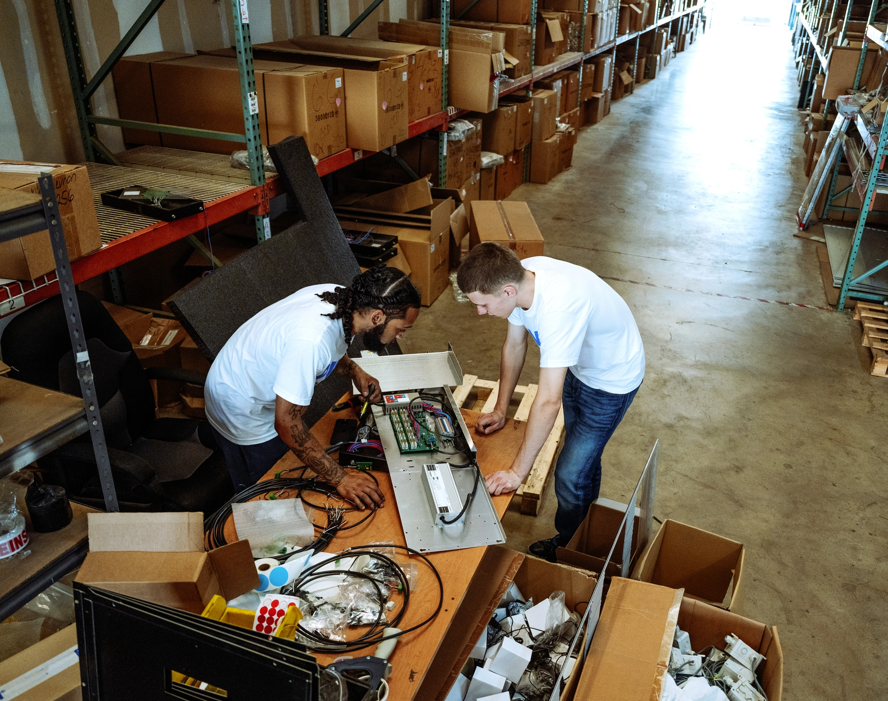Warehouse workers assembling electronics